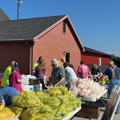 Bagging fresh mobile vegetables before distributing.