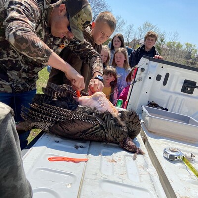 A few of the kids learning how to clean a turkey.