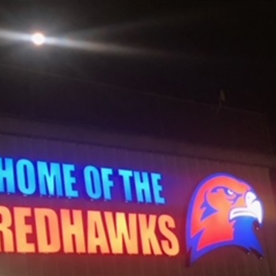 Home of the Redhawks Sign at Night