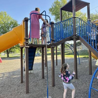 Teacher at her post blocking pole access! This is the elementary-aged playground.
